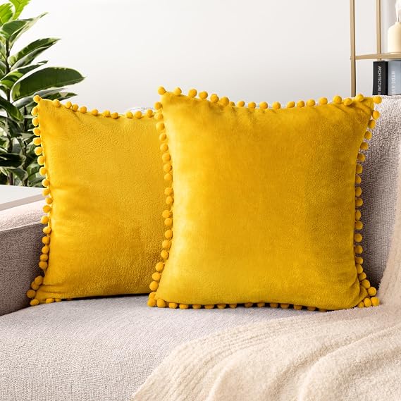 PAVILIA Mustard Yellow Decorative Throw Pillow Cover Pom Pom 18x18 Set of 2 | Soft Plush Velvety Fleece Cushion Covers with Pompom Trim, Boho Aesthetic Fuzzy for Couch Sofa Bed Bedroom Living Room Decor